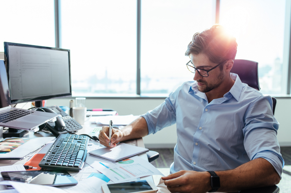 Man sitting at office desk experiencing burnout
